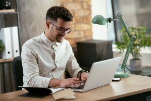 A guy sitting in front of computer
